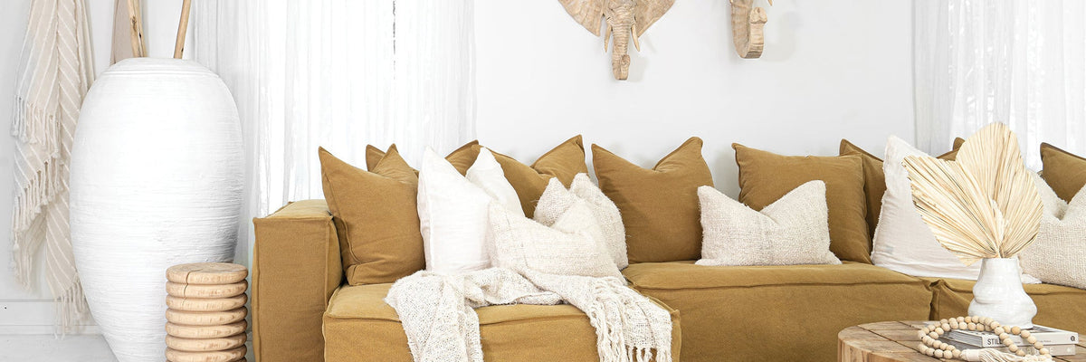 Uniqwa Hendrix sofa in ochre with timber furniture and natural textures in a light indoor living space