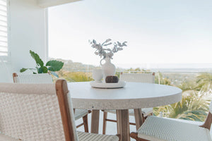 Round concrete dining table in ivory, Magnolia Lane coastal living