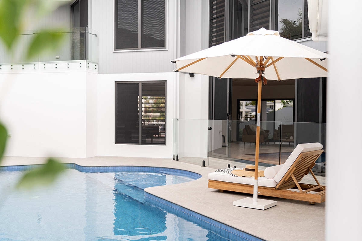 Amalfi Outdoor Parasol with teak pole and marine-grade fittings, round Sunproof Copacobana shade, elegant coastal outdoor umbrella for poolside or garden. Resort style living.