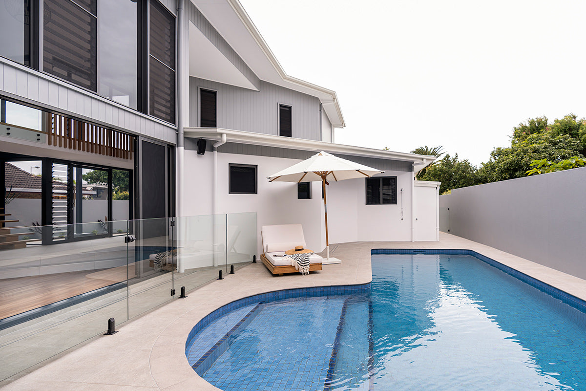 Amalfi Outdoor Parasol with teak pole and marine-grade fittings, round Sunproof Copacobana shade, elegant coastal outdoor umbrella for poolside or garden. Coastal poolside living.