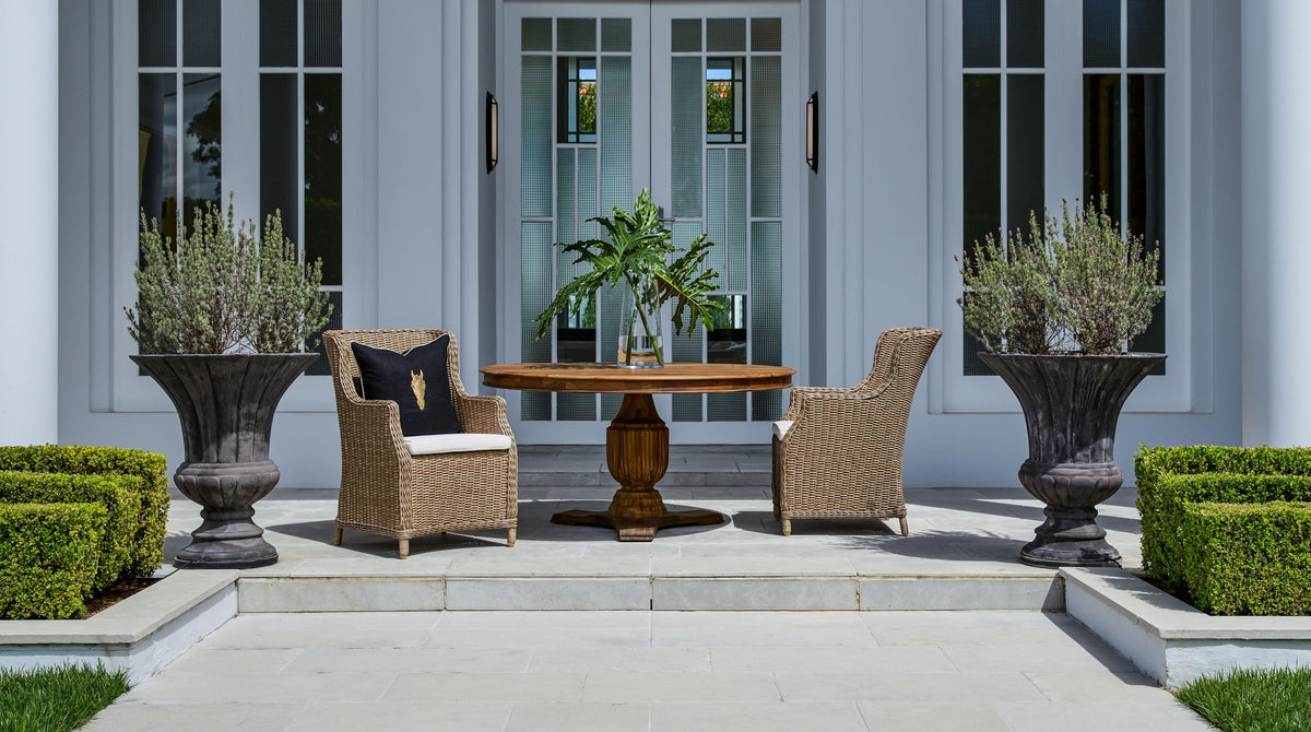 Ashford natural woven outdoor dining chairs styled around a dining table on an alfresco terrace