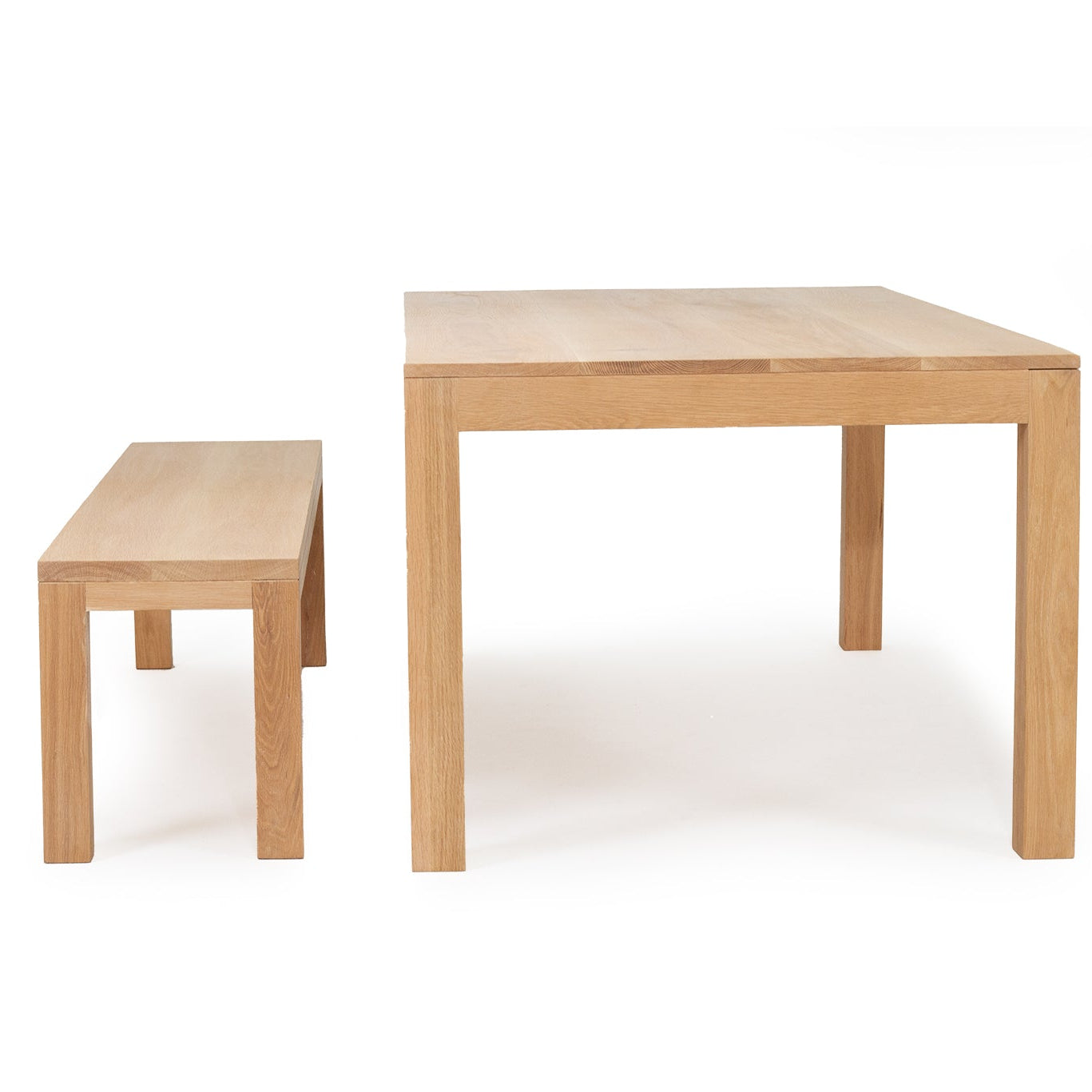 Austin dining table in solid American oak with natural finish and bench side view
