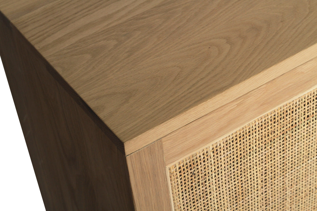 Beach House 300cm natural oak and rattan sideboard, close-up of the oak tabletop corner and rattan door