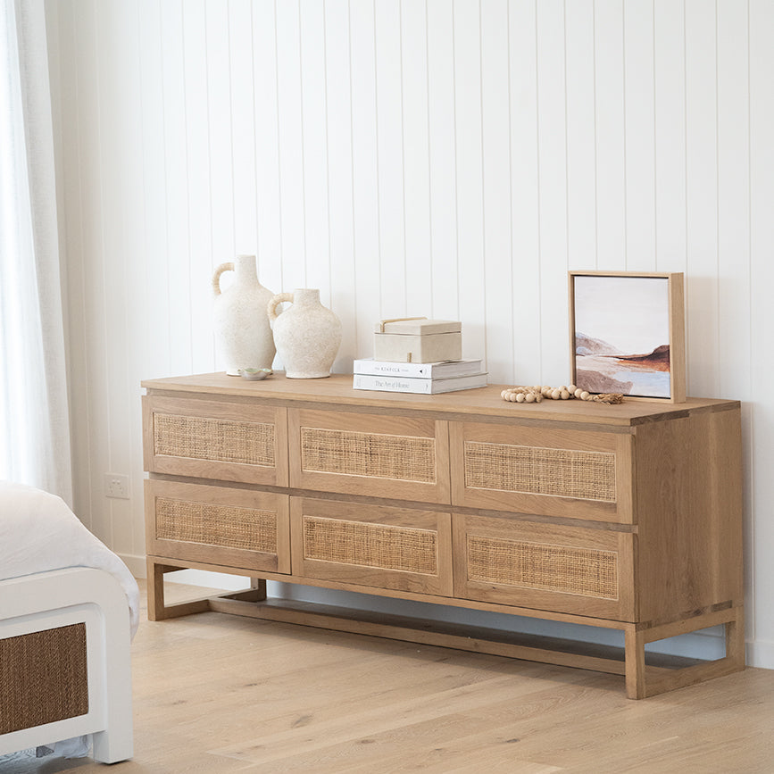 Beach House six-drawer oak chest in a light coastal bedroom, portrait view