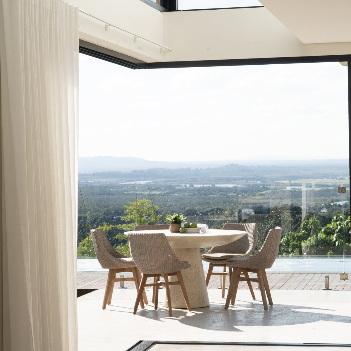 Beach House Outdoor Dining Chairs in Mushroom and natural teak styled on an outdoor patio