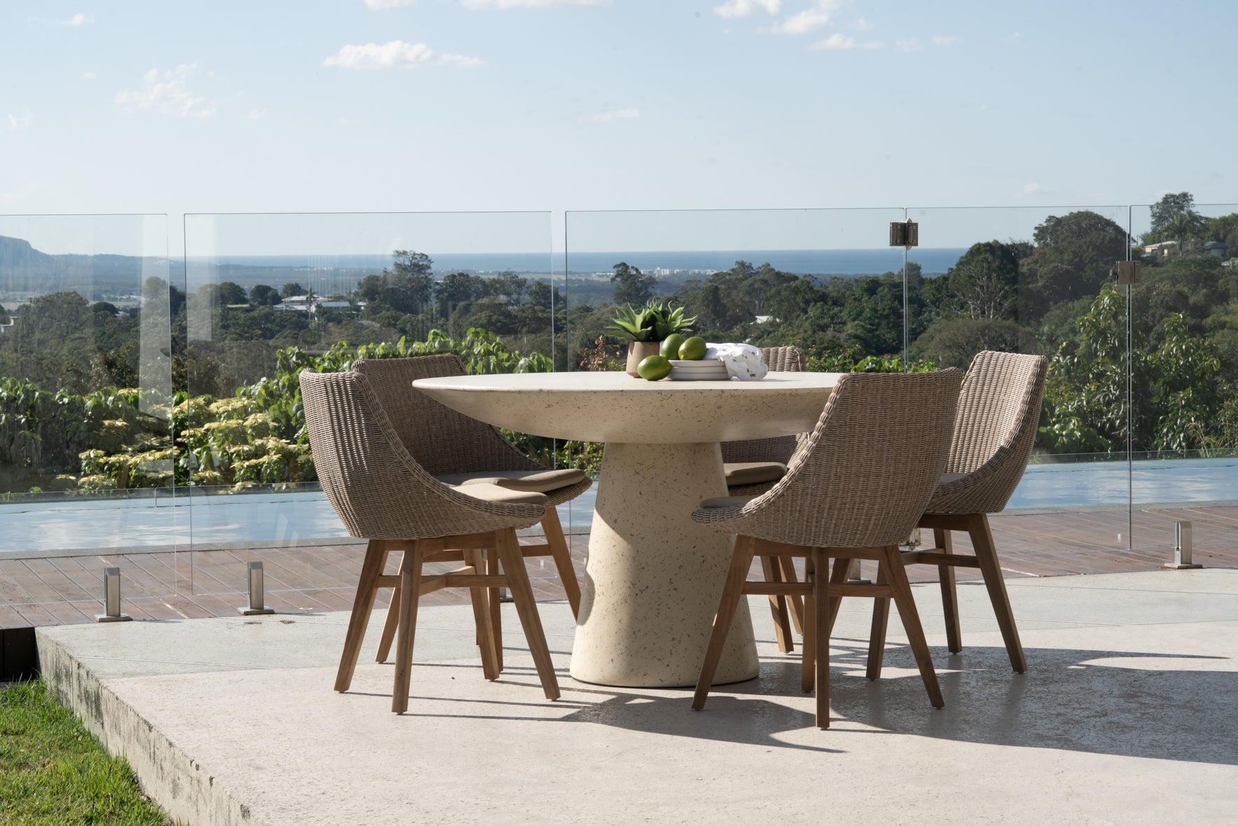 Beach House Mushroom Outdoor Dining Chairs styled around a teak table in an outdoor dining setting