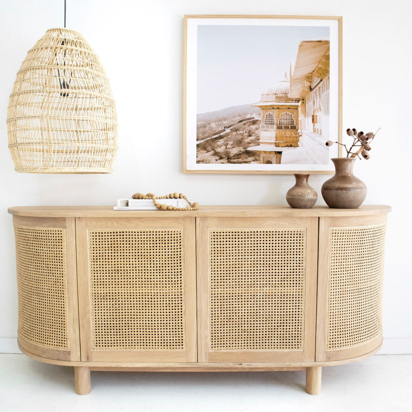 Solid oak sideboard with curved edges styled in coastal living room front view