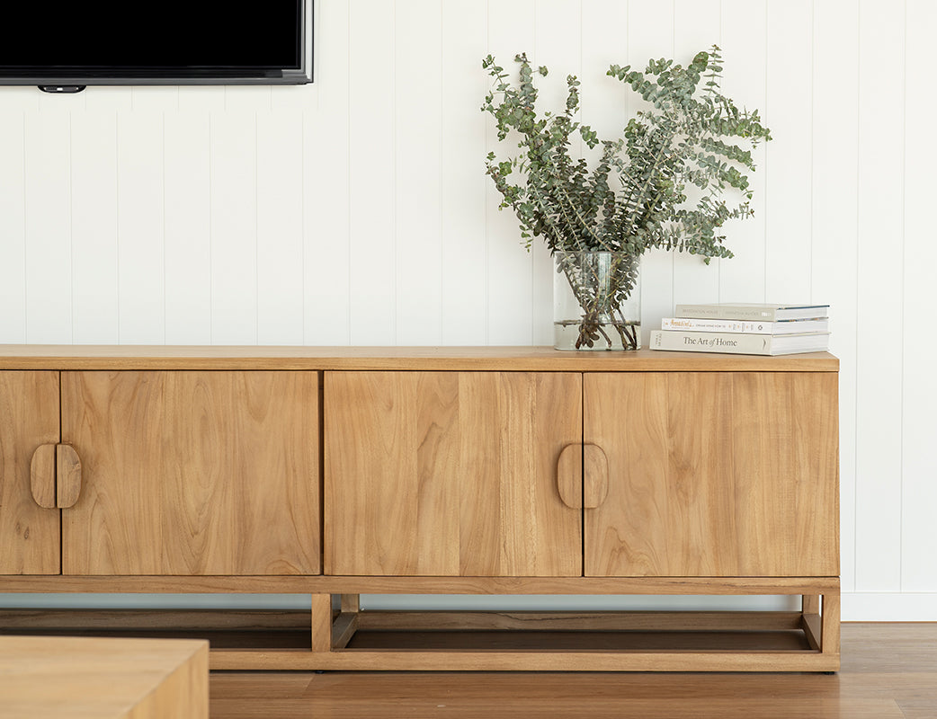 Benji 3m natural teak entertainment unit styled beneath a wall-mounted television with greenery and books