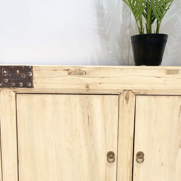 Four-door sideboard made from reclaimed timber with antique brass handles, rustic coastal style. Close up perspective.