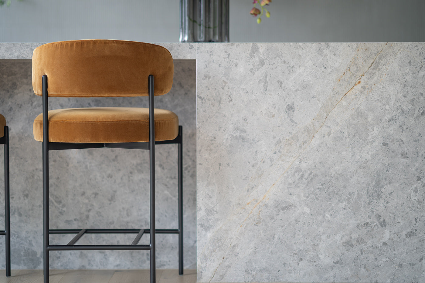 Fontaine Counter Stool with half-moon curved back and metal legs, upholstered in performance velvet in amber, modern Art Deco inspired counter stool for elegant interiors. Modern kitchen counter stool.