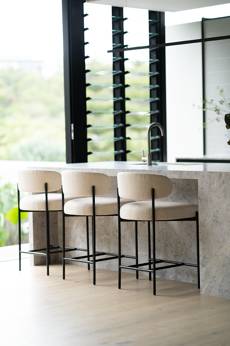 Fontaine Counter Stool with half-moon curved back and metal legs, upholstered in performance linen, modern Art Deco inspired counter stool for elegant interiors. Modern elegance.