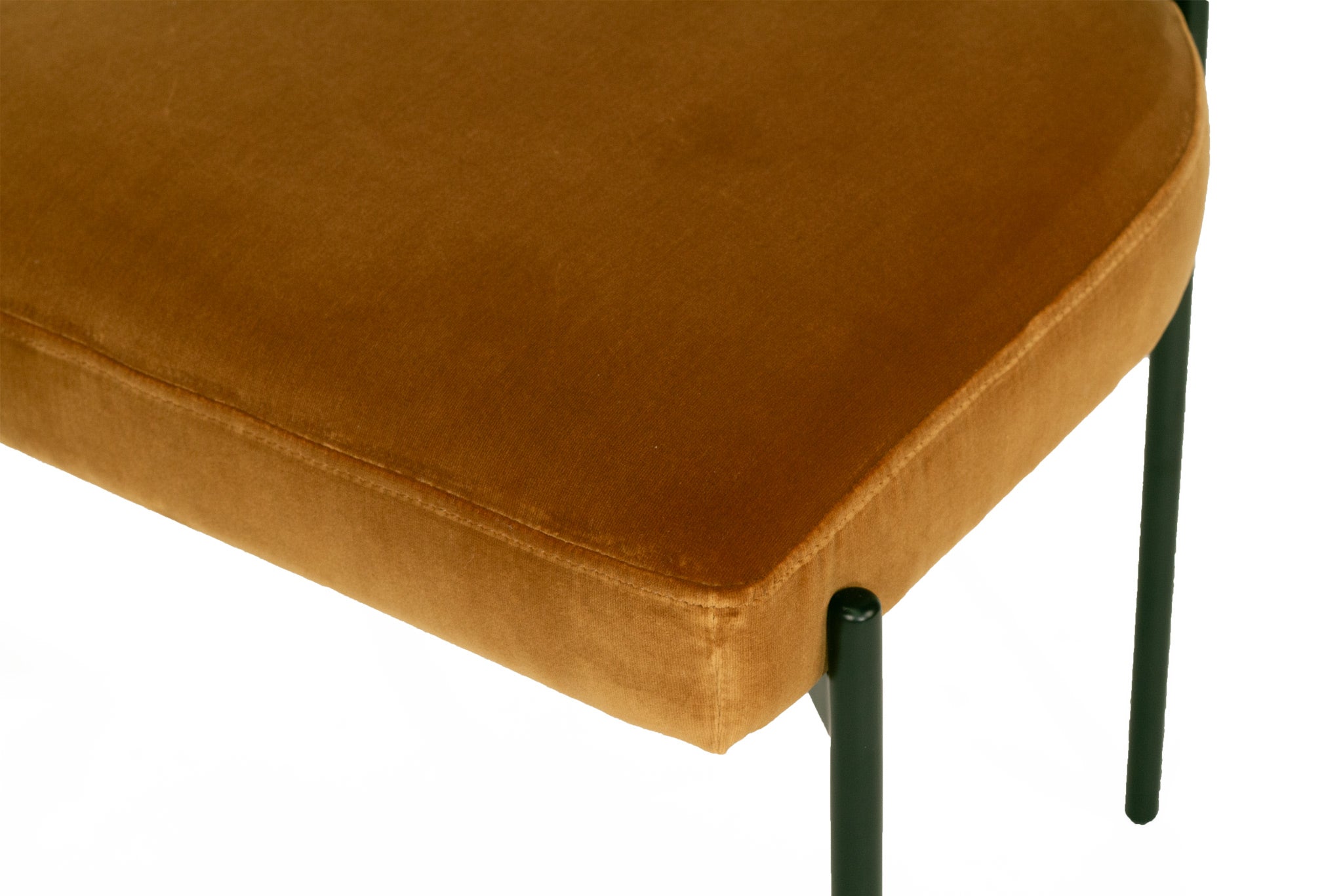 Fontaine Dining Chair with half-moon curved back and metal legs, upholstered in performance amber velvet, modern Art Deco inspired dining chair for elegant interiors. Close up seat.