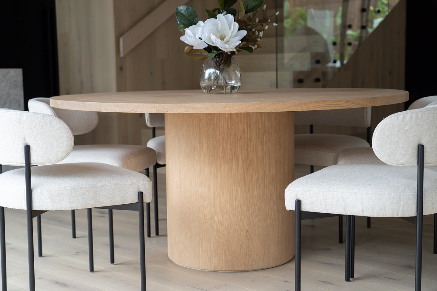 Fontaine Dining Table in solid American Oak with oak veneer base, handcrafted with fine sanded raw finish, modern coastal dining furniture for timeless interiors. Modern dining interior.