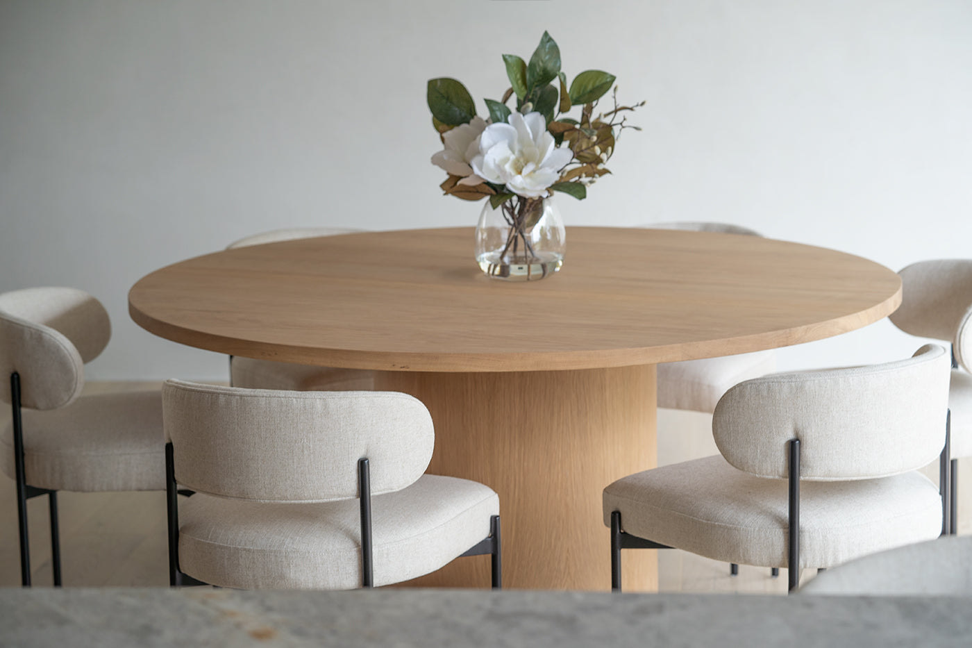 Fontaine Dining Table in solid American Oak with oak veneer base, handcrafted with fine sanded raw finish, modern coastal dining furniture for timeless interiors. Modern dining room.