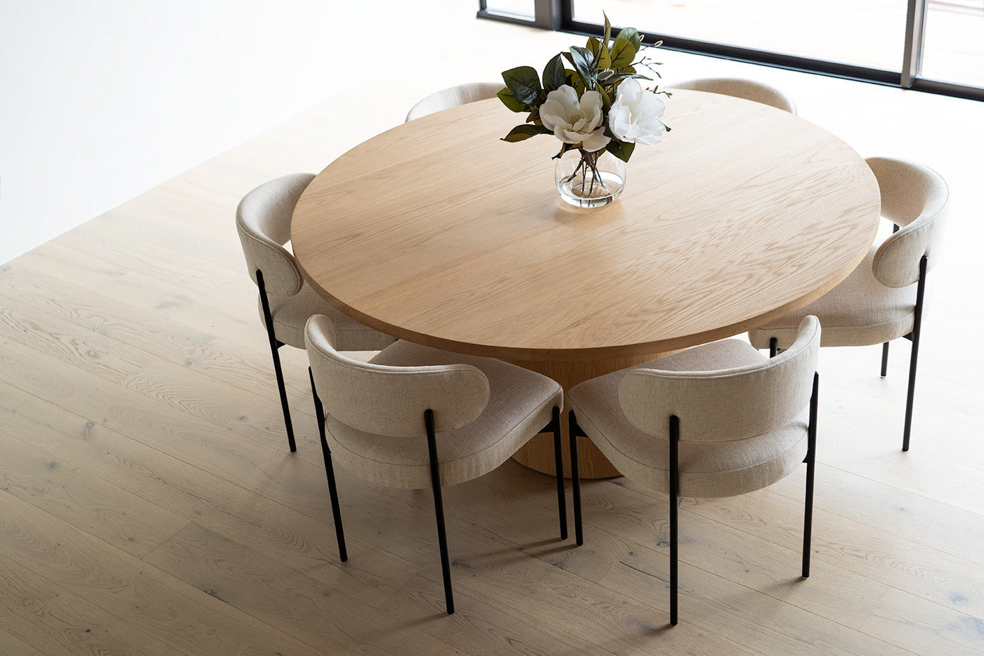 Fontaine Dining Table in solid American Oak with oak veneer base, handcrafted with fine sanded raw finish, modern coastal dining furniture for timeless interiors. Modern coastal dining.