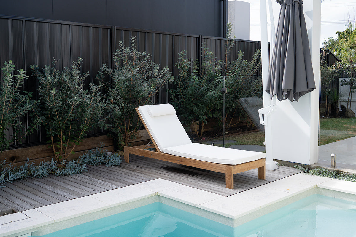 Harbour Island Slim Outdoor Sunlounger in Grade A teak with white Sunbrella cushion, adjustable backrest and wheels, coastal outdoor furniture for poolside or garden relaxation. Relax poolside.