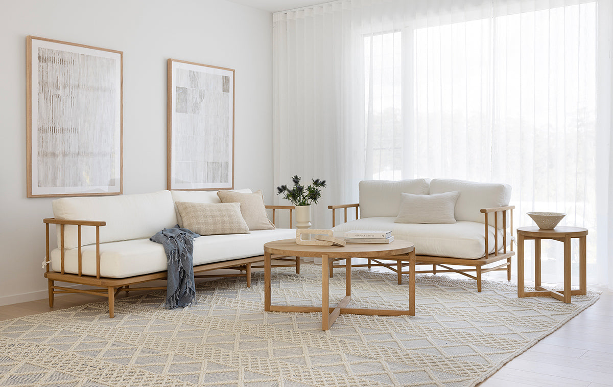 The Harbour Island Two Seater Sofa with light timber frame and white cushions – coastal luxe design perfect for relaxed coastal interiors