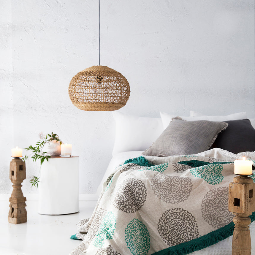 Lili Round Woven Pendant Light by Uniqwa Collections styled in a modern coastal bedroom, showcasing natural woven banana fibre texture and organic pendant lighting design.