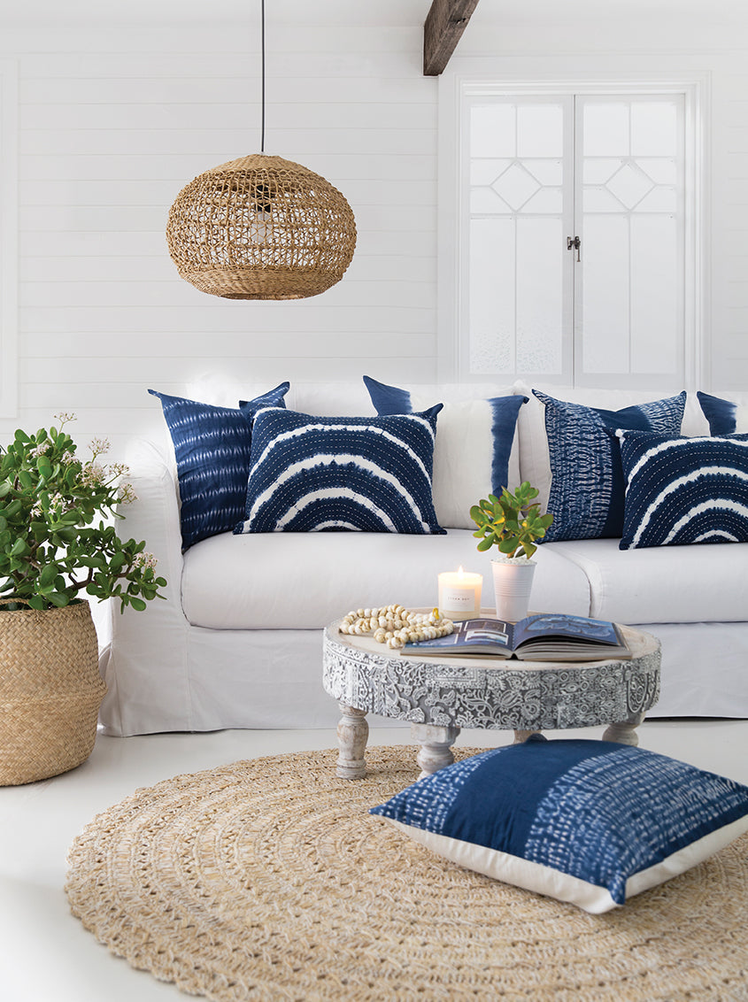 Lili Round Woven Pendant Light by Uniqwa Collections styled in a coastal living room, showcasing natural woven banana fibre texture and organic pendant lighting design.