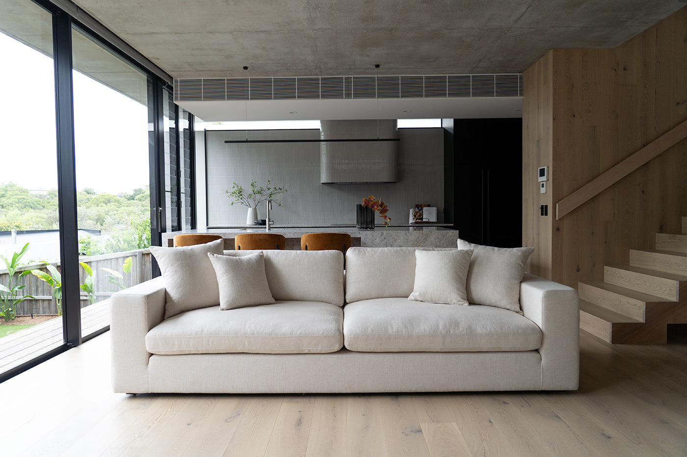 Lucca Four Seater Sofa in performance linen blend upholstery in Dune, refined design, available in boucle oatmeal or saddle leather. Styled beautifully in this modern home.