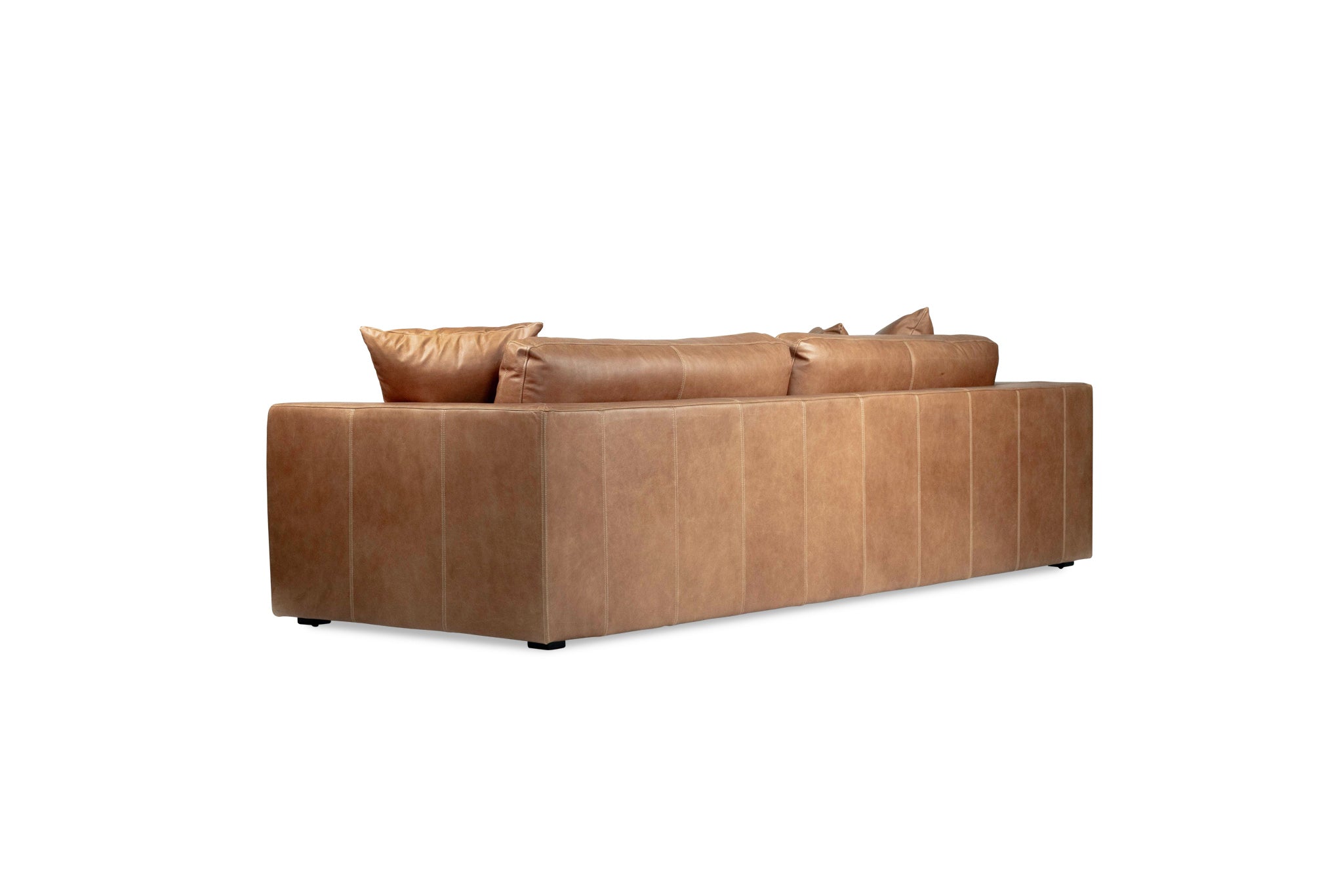 Lucca Four Seater Sofa in trend saddle tan leather with sleek, sophisticated design. Back angle perspective.