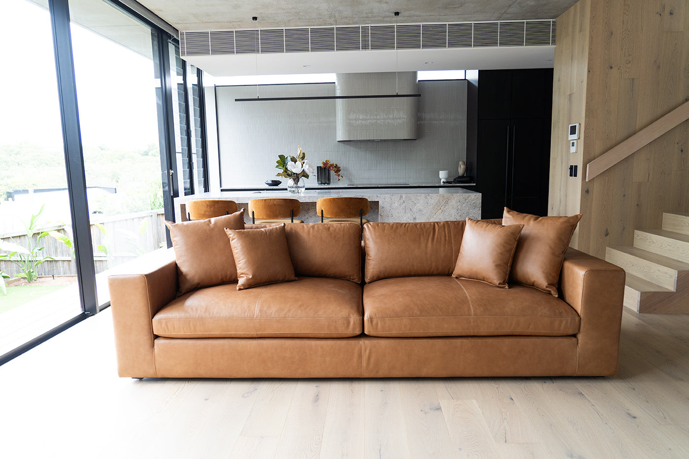 Lucca Four Seater Sofa in trend saddle tan leather with sleek, sophisticated design. Front perspective.