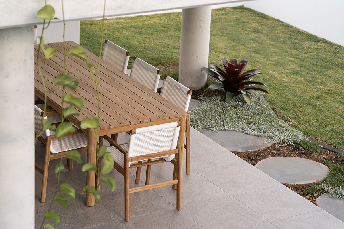 Noosa 2.4m teak outdoor dining table with outdoor chairs on a covered patio