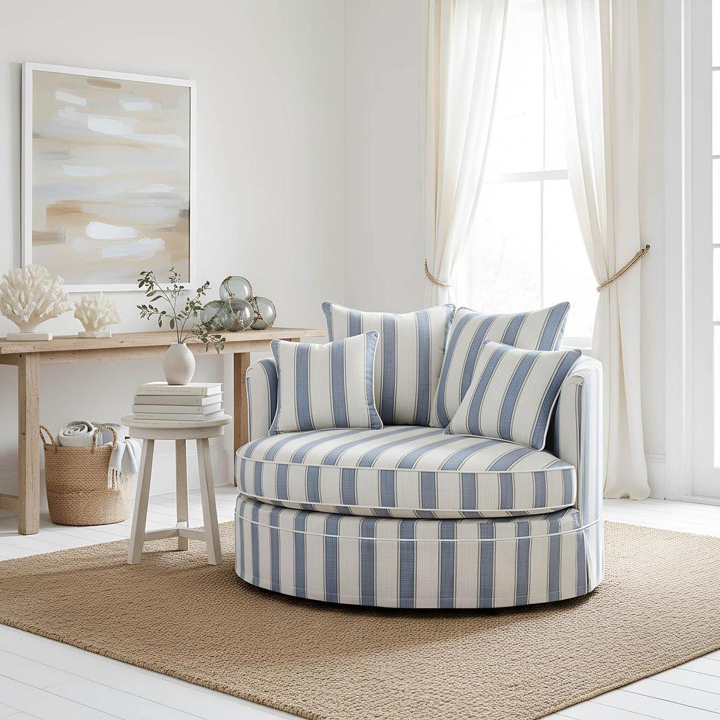 Noosa snuggle occasional chair in Blue Sky Stripe, styled with cushions and a side table in a living room