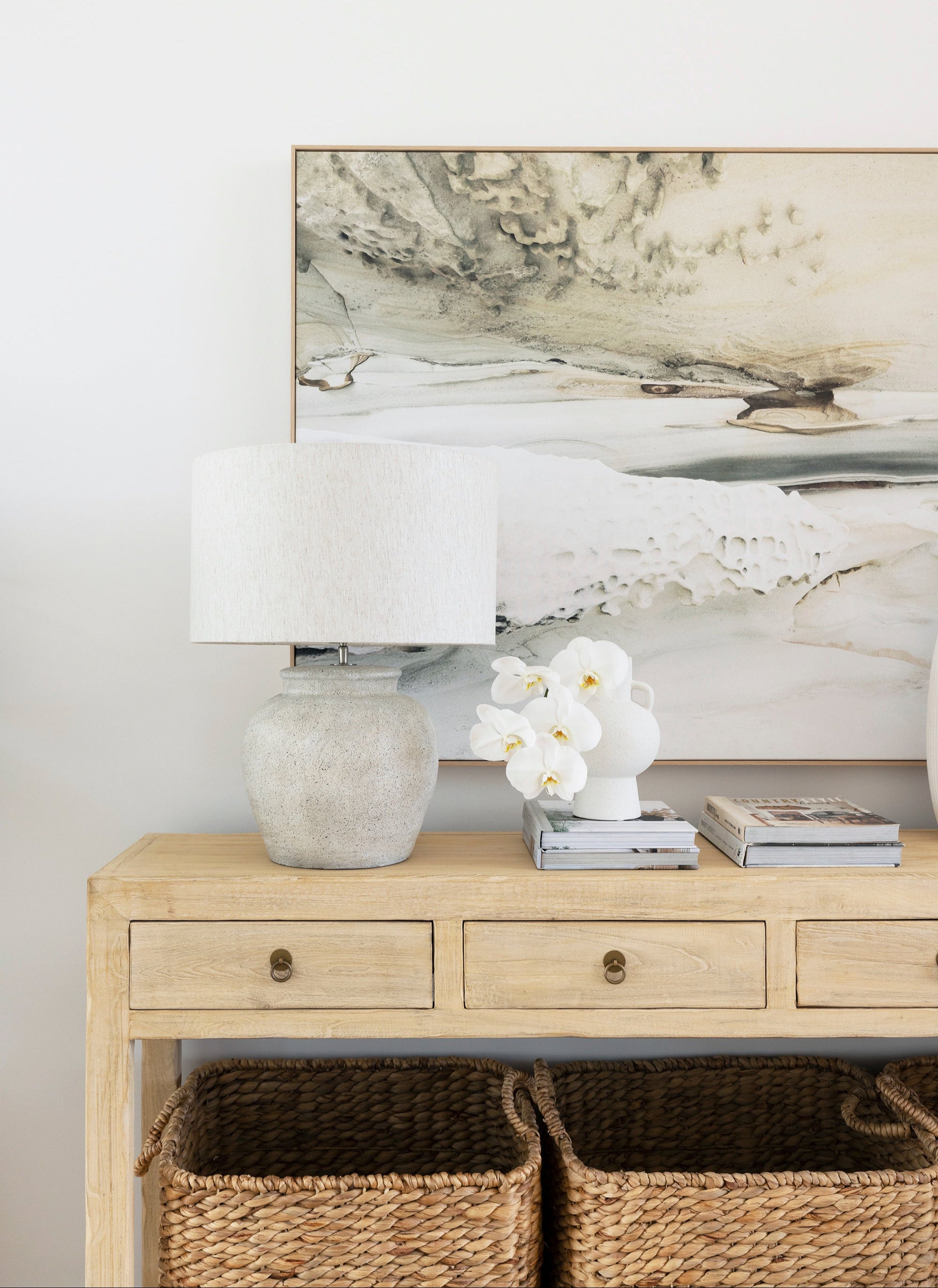 Reclaimed timber console table with four drawers and brass-look metal handles, handcrafted coastal furniture combining rustic and contemporary design for a warm, natural interior. Magnolia Lane modern coastal interior 1.