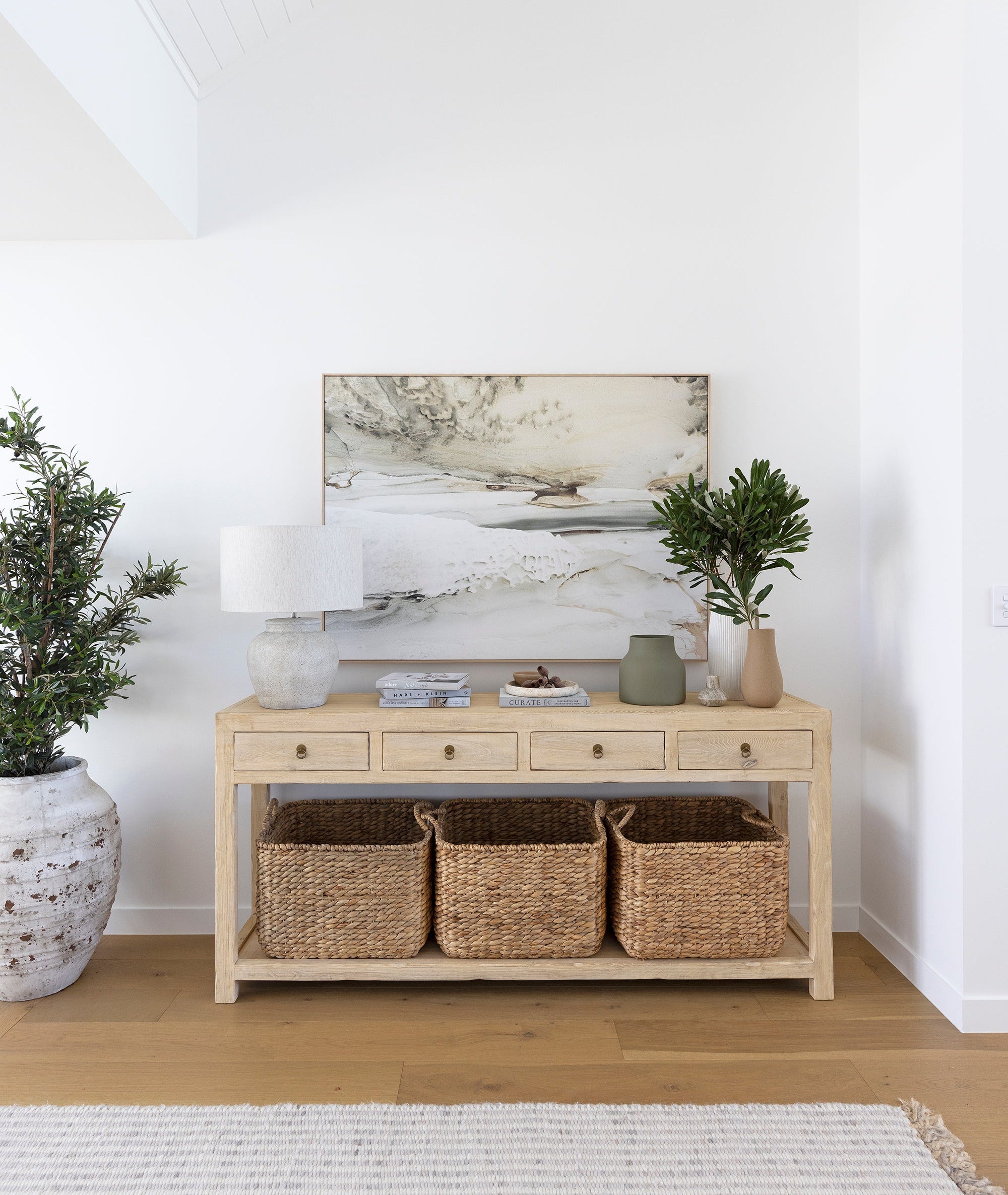 Reclaimed timber console table with four drawers and brass-look metal handles, handcrafted coastal furniture combining rustic and contemporary design for a warm, natural interior. Magnolia Lane modern coastal interior.