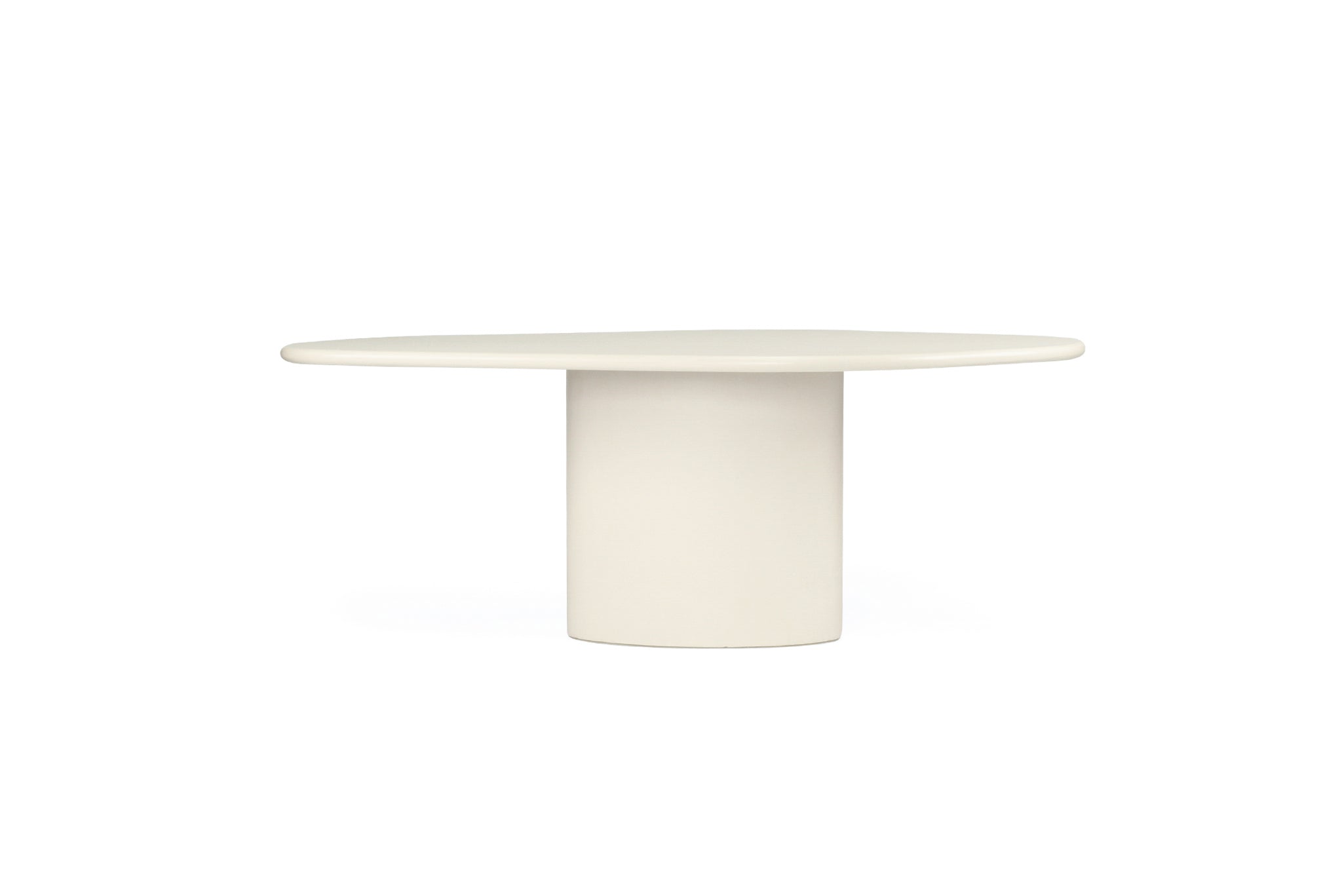 Saint Tropez Dining Table with ivory micro cement finish – modern coastal design with organic shape and refined matte texture - side perspective