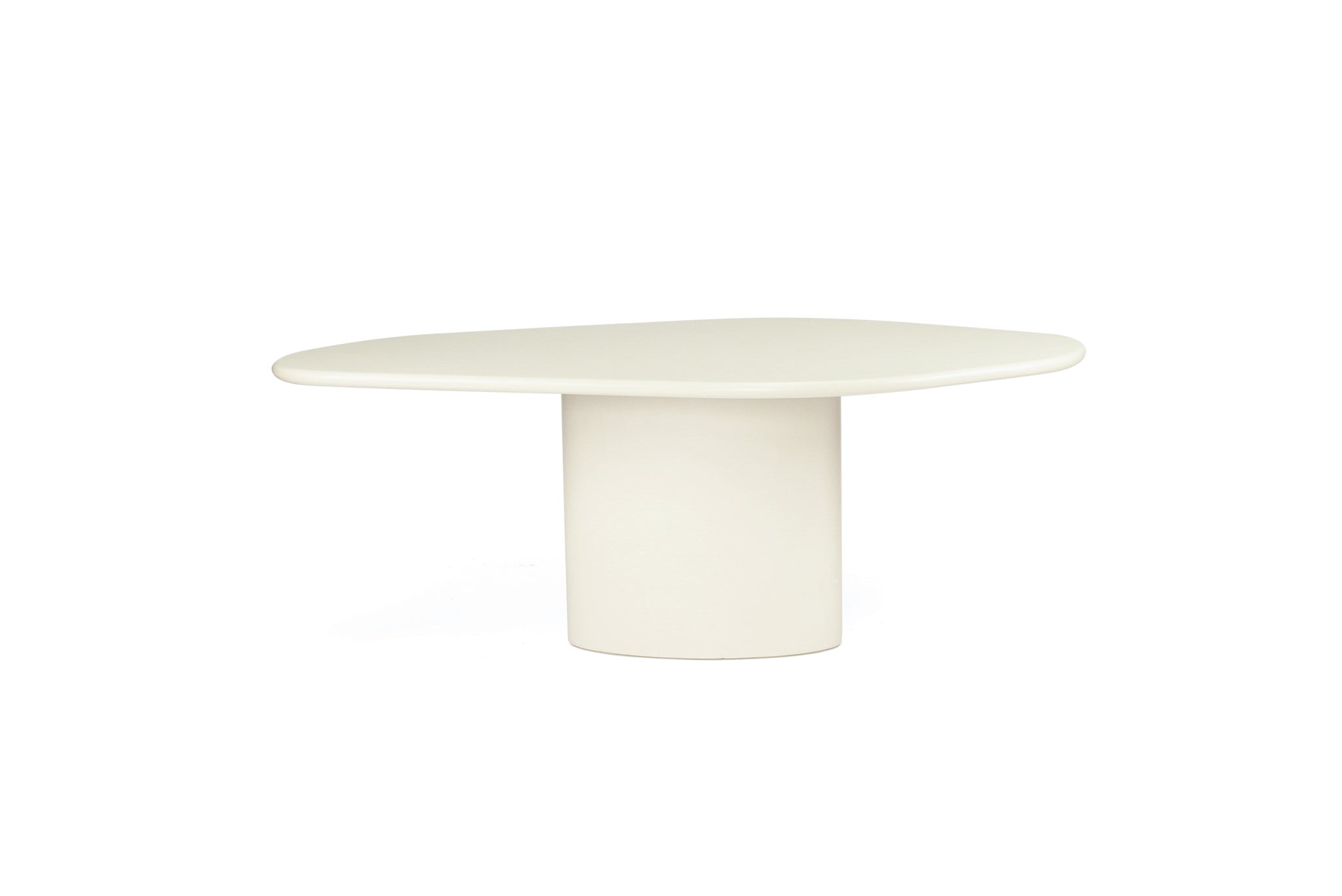 Saint Tropez Dining Table with ivory micro cement finish – modern coastal design with organic shape and refined matte texture - overall perspective 1
