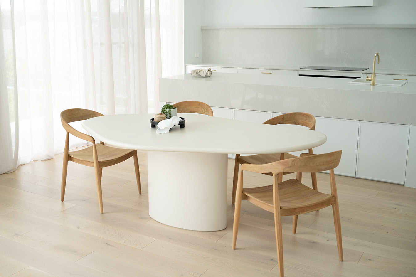 Saint Tropez Dining Table with ivory micro cement finish – modern coastal design with organic shape and refined matte texture