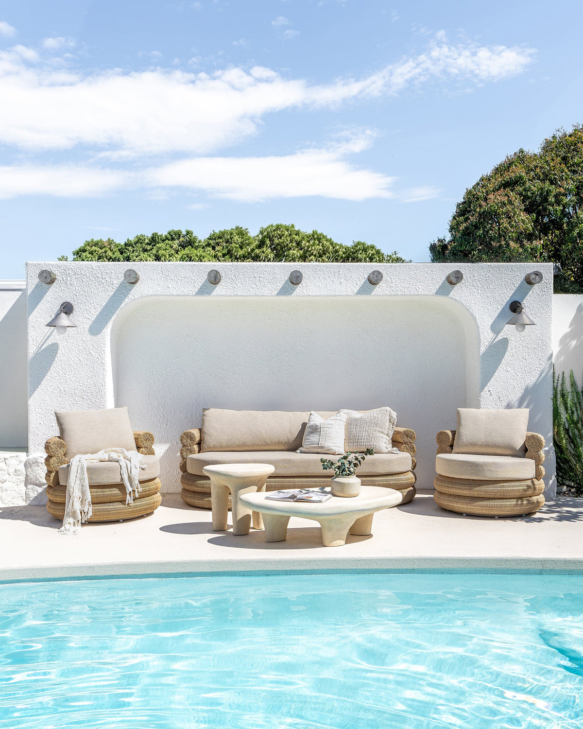 Satori outdoor swivel chairs and matching sofa in a poolside lounge setting