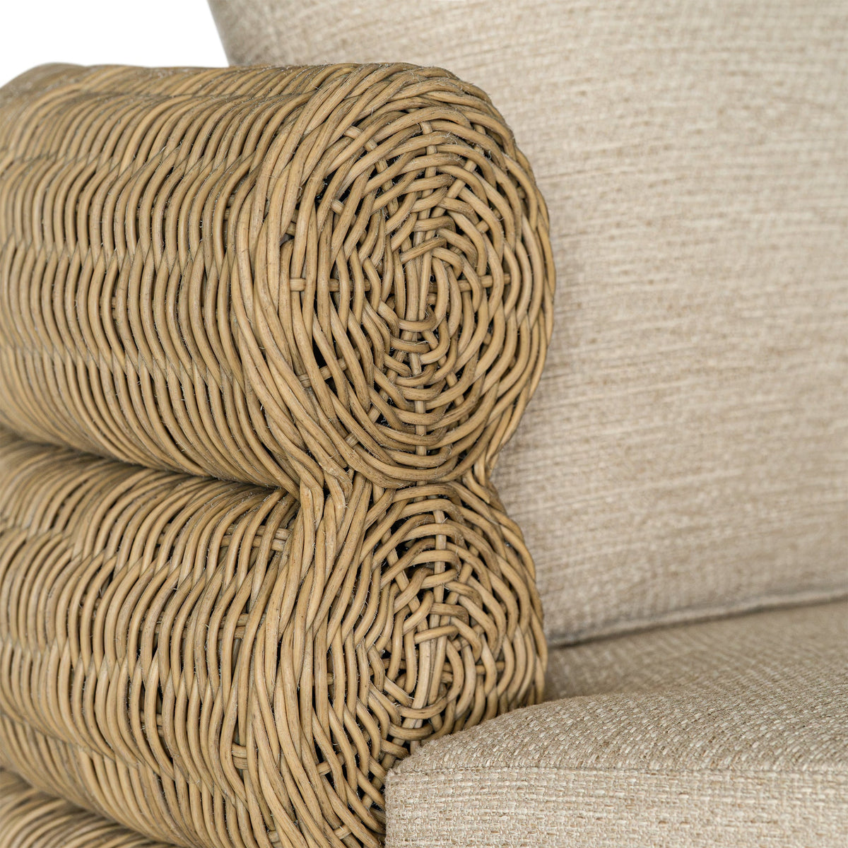 Satori outdoor swivel chair, close-up of the rounded woven arm and back cushion