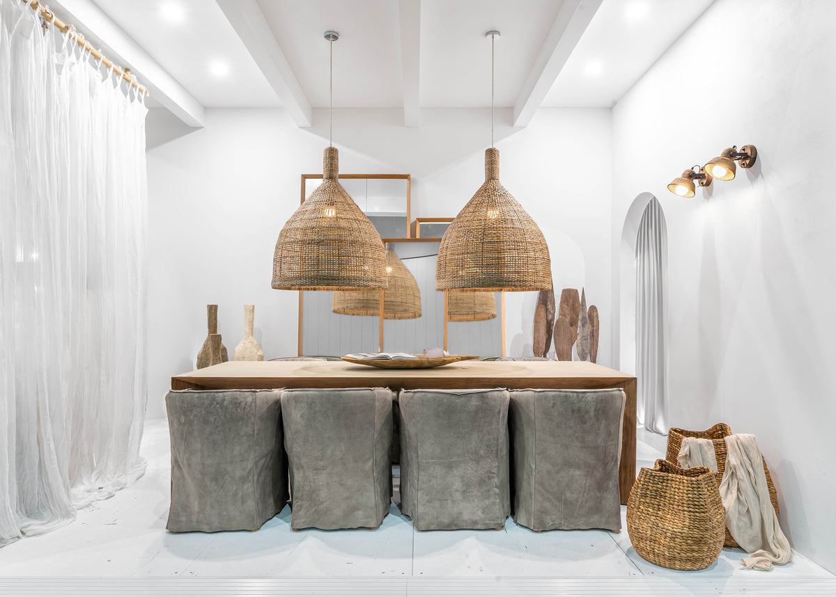 Soul Rattan Pendant by Uniqwa Collections styled above a dining table in an organic modern home.