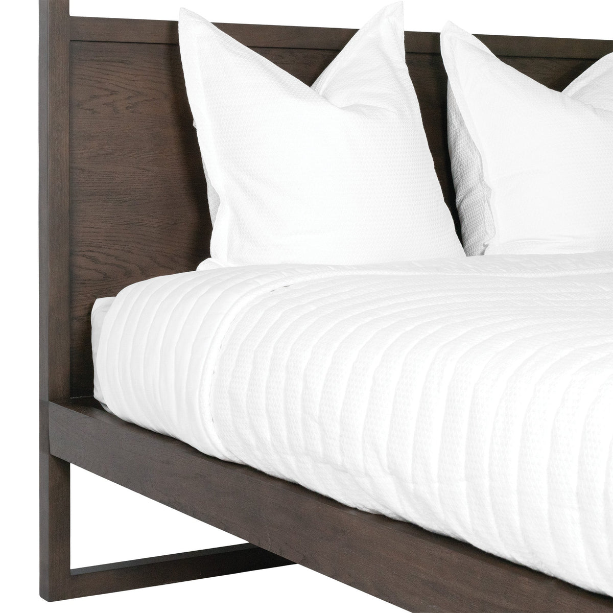 Close-up of the Strand bed walnut-coloured oak headboard and side rail
