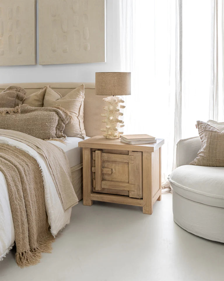 Bulu Bedside Table with right-hand door, handcrafted from reclaimed timber with natural weathered texture and carved details, coastal organic furniture with timeless character. Modern coastal luxe bedroom suite.