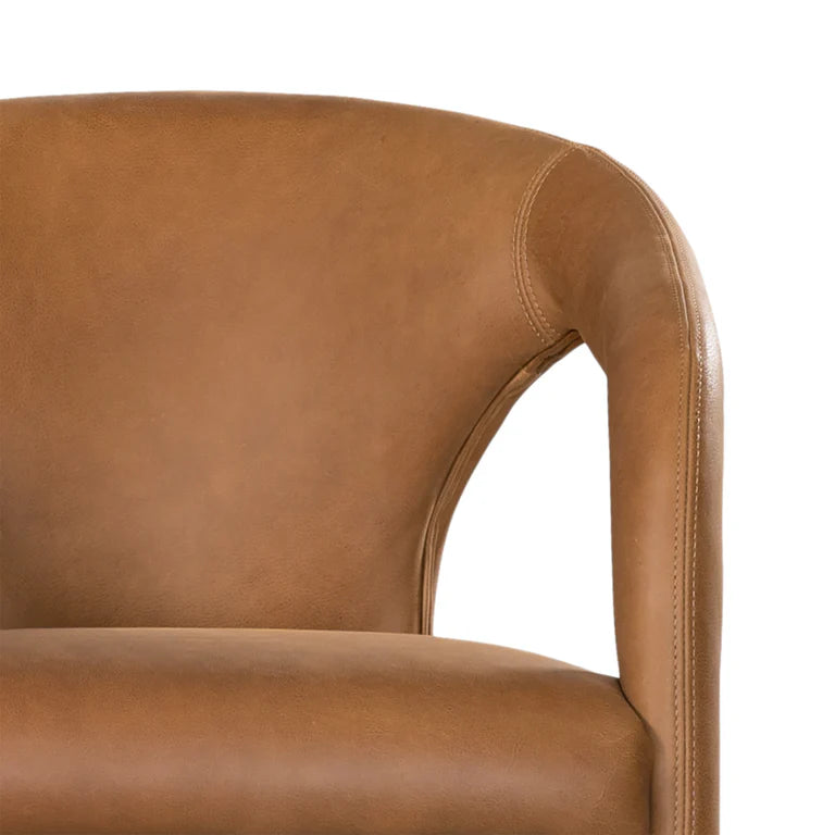 Fikile Dining Chair – contemporary chair with swooping open back, upholstered leather seat, and rounded silhouette, blending vintage style with modern elegance for dining or accent use. Close up detail