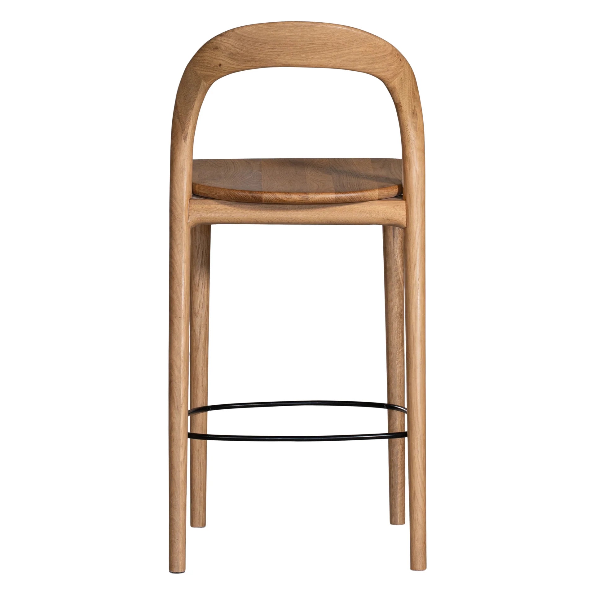 Loki Bar Chair in solid oak with natural finish, featuring sculptural minimalist design, rich wood grain, and black iron footrest for a modern touch. Back perspective.