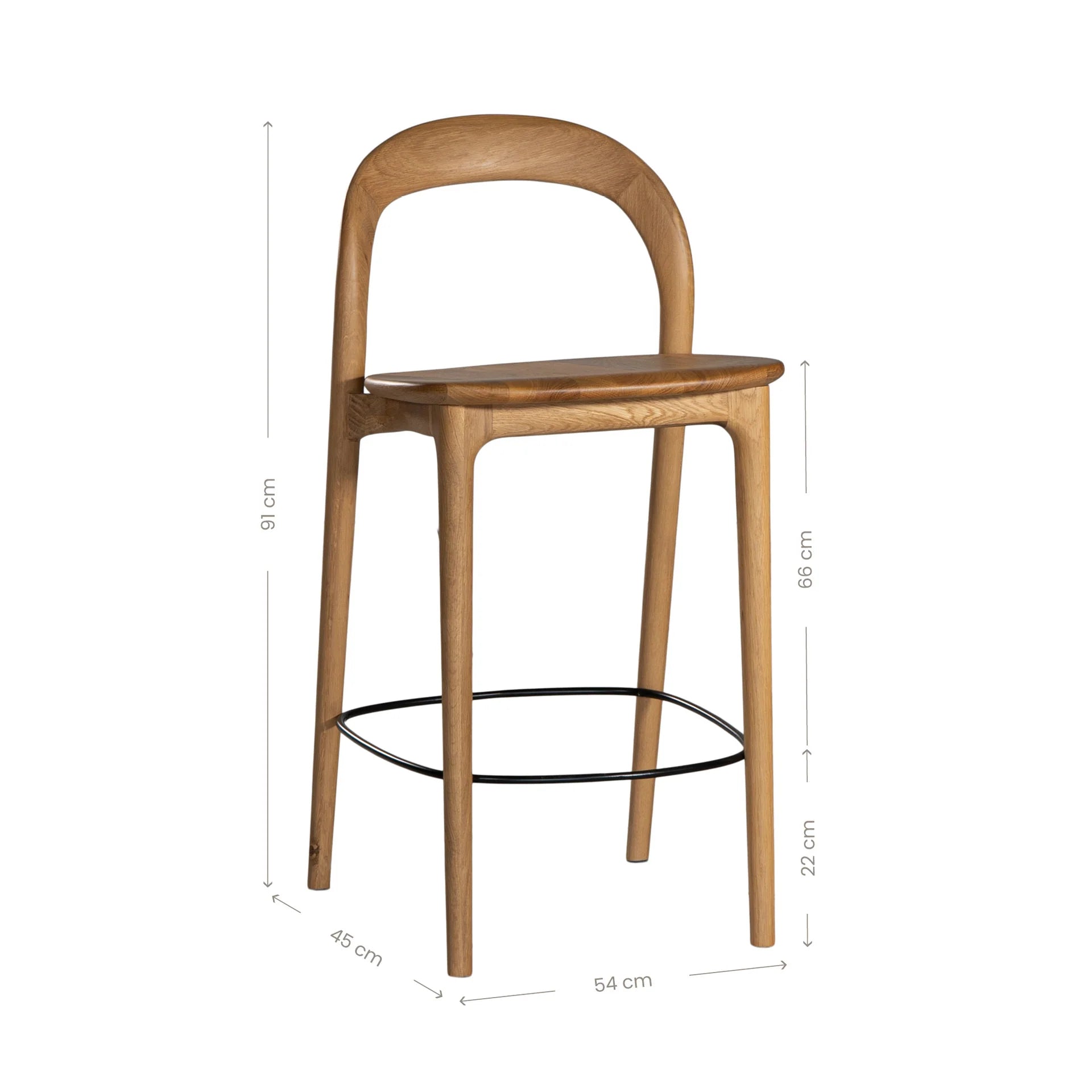 Loki Bar Chair in solid oak with natural finish, featuring sculptural minimalist design, rich wood grain, and black iron footrest for a modern touch. Product dimensions.