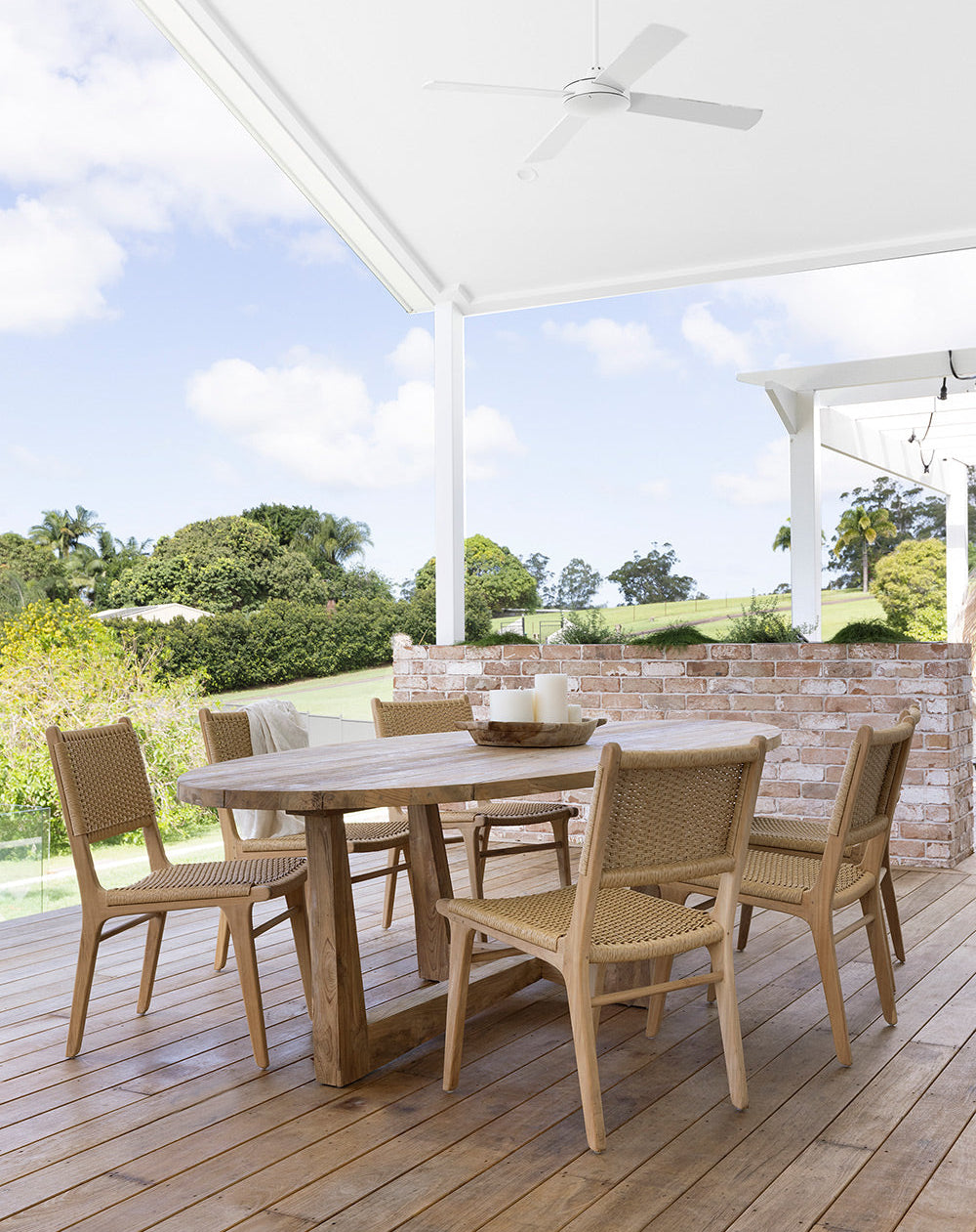 Cable Beach closed weave teak dining chairs styled in a coastal outdoor dining setting