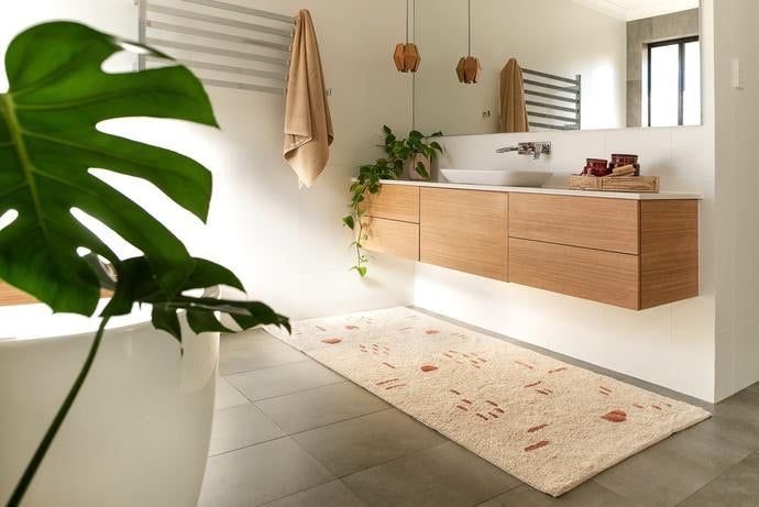 Nomad XL Bath Runner – handwoven, plush bath mat in neutral tones for luxurious bathroom or home accent decor. Styled to perfection in this modern bathroom.