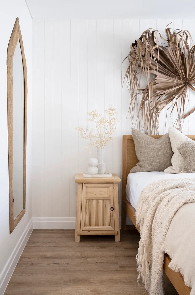 Karoo Mirror by Uniqwa Collections, handcrafted from rare antique Indonesian teak ploughs, showcasing unique shapes and rich cultural heritage. Styled in this modern villa style bedroom.