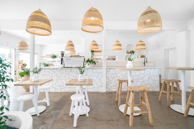 Handmade reclaimed elm wood barstool with bleached finish, featuring natural variations for a unique coastal or villa style. By Uniwqa Collections, sold by Magnolia Lane Australia wide delivery. Styled in this beautiful restaurant.ommercial