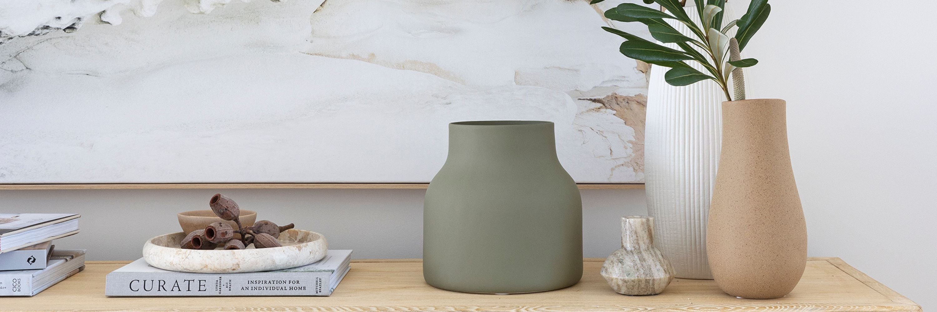 Interior décor and homewares styled in a contemporary living space featuring sculptural vases and decorative objects.