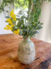 Load image into Gallery viewer, Handcrafted ceramic Sake Jug with light green drip glaze on a speckled finish, styled as a bud vase with a beautiful Mt Morgan wattle cutting.