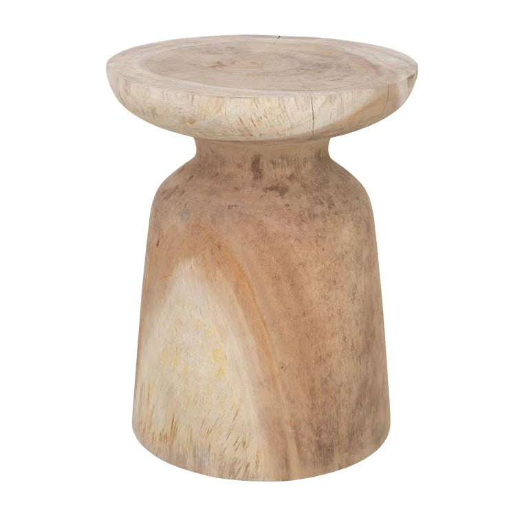Akoni Side Table – hand-carved munggur wood side table with smooth sanded finish, unique natural design crafted using traditional techniques.  Styled beautifully in this bedroom. Front perspective.