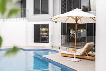 Load image into Gallery viewer, Amalfi Outdoor Parasol with teak pole and marine-grade fittings, round Sunproof Copacobana shade, elegant coastal outdoor umbrella for poolside or garden.  Resort style living.