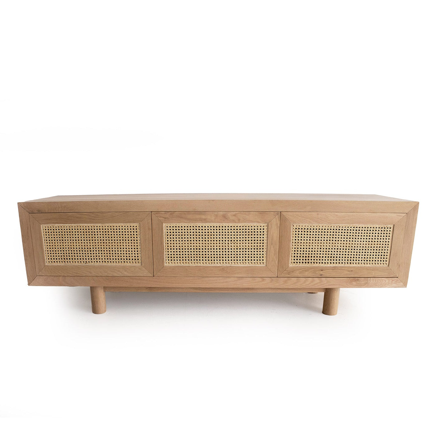 Solid oak TV unit with rattan panels and push to open doors angled front view